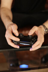 Playing games concept. Part body man with joystick play game on console. Male hands holding pad. High quality photo