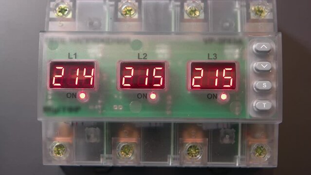 Voltage surge protectors relays with lighting digits. Working factory switchgear equipment.