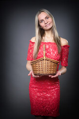 A woman holds a small basket in her hands