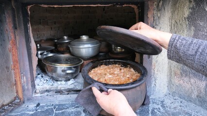 Cooking in a pot. Cooking in the village oven.