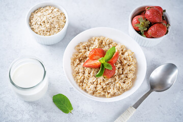 Oatmeal porridge with strawberries in a bowl