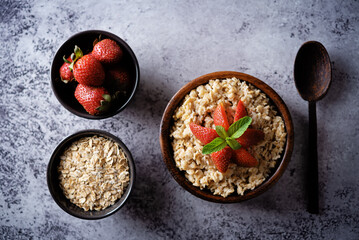 Oatmeal porridge with strawberries in a bowl