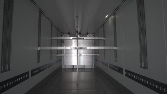 cargo empty semi-trailer with clean floor, modern freight transport.shot inside a cargo empty clean semi-trailer.Back view close-up.