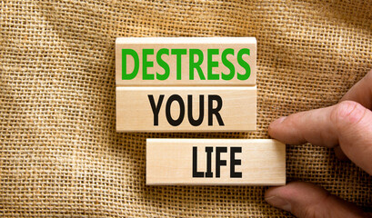 Destress your life symbol. Concept words Destress your life on wooden blocks. Doctor hand....