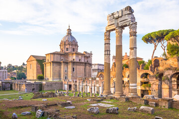 Sunrise light with blue sky on Roman ancient architecture in Rome, Italy