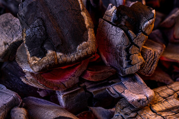 Glowing Hot Charcoal Background Texture. Red hot coals in the grill close up. hot red coals among black ash, wallpapers for mobile devices, abstract.