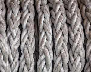 Gray synthetic ship rope wound on drum close-up.