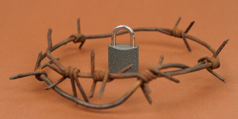 On a brown surface there is a castle with barbed wire around it.