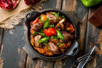 Ojakhuri georgian kitchen, with veal and fried potatoes on wooden table top view