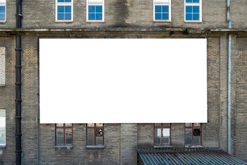 Blank white advertising billboard on the wall of old building