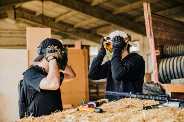 Airsoft soldiers preparing for battle at training ground