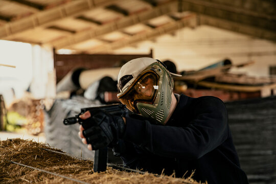 Soldier aiming airsoft gun during tactical game