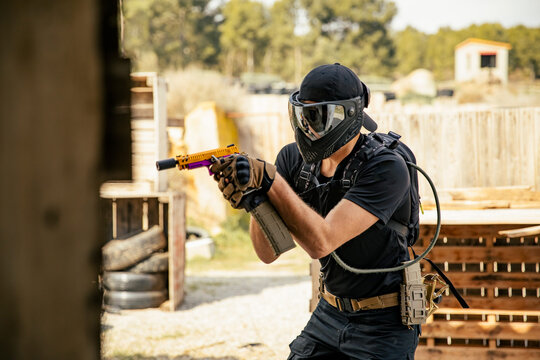 Soldier aiming airsoft gun during tactical game