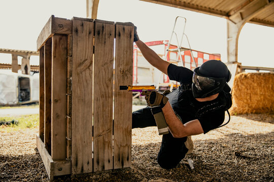 Soldier aiming airsoft gun during tactical game