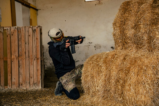 Soldier aiming airsoft gun during tactical game