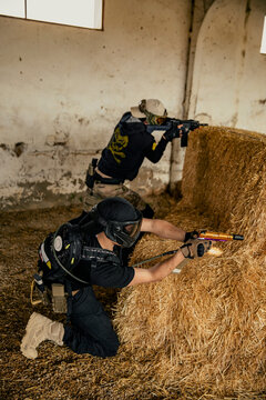 Soldiers aiming airsoft gun during tactical game