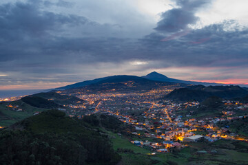 Dusk from the Jardina viewpoint, illuminated town, Teide volcano