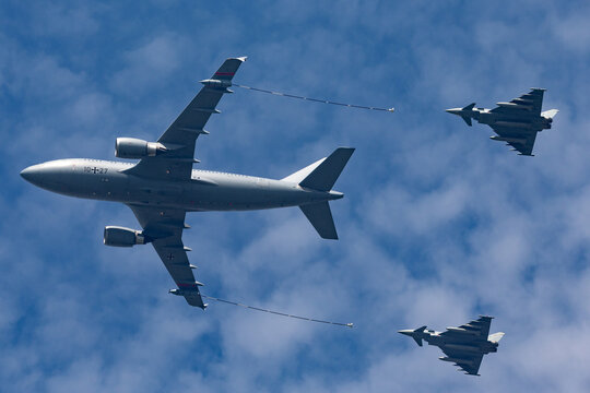 Payerne, Switzerland - September 7, 2014: German Air Force (Luftwaffe) Airbus A310-304 aerial refuelling aircraft refuelling two Eurofighter Typhoon fighter aircraft.