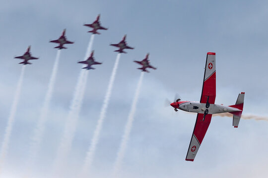 Payerne, Switzerland - September 1, 2014: Swiss Air Force Pilatus PC-7 aircraft crossing in front of the Northrop F-5 aircraft from Patrouuille Suisse.