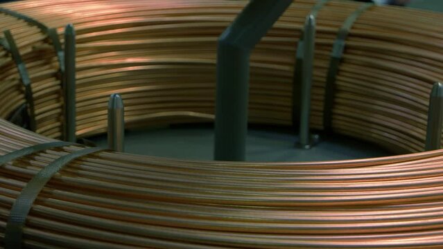 Close-up large copper pancake coil of thick wires. Industrial factory electromagnet.