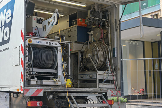 Lubeck, Germany, May 4, 2022: Truck with equipment for sewer works such as hoses, pneumatic pumping unit, cables and machines, professional technology on a construction site