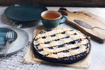 Classic homemade blueberry pie on crochet linen napkin