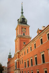Fototapeta na wymiar Warsaw, Poland, 13 October 2021: Royal Castle with clock tower in old town, residence official home of Polish monarchs, fortified complex at sunny autumn day, Main square with Sigismund Column