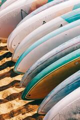 Close-up of colorful paddle boards for rent