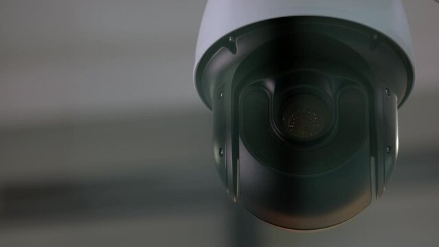 Close-up of surveillance video camera rotating around. Security and safety.