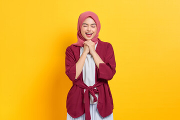 Overjoyed beautiful Asian woman in casual shirt smiling happy and looking confident isolated over yellow background