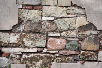 Close-up view of a segment of a vintage deteriorating stone wall