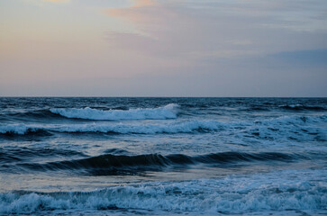 Fototapeta premium Waves washing ashore a sandy beach, Virginia Beach. 