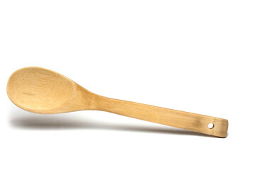 Closeup light wooden cooking spoon white background