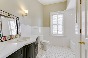 Interior staged bathroom single vanity marble plantation shutter
