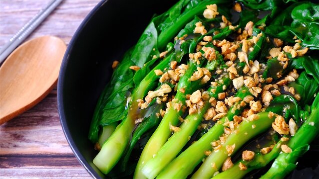 Chinese kale in oyster sauce top with fried garlic.