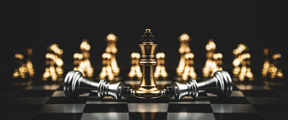Fototapeta King stand with falling chess on chessboard concepts winner of leader teamwork volunteer challenge of business team or wining and leadership strategy and organization risk management or team player. obraz