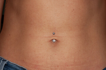 Belly button piercing. Girl's navel. Titanium piercing jewelry - banana with two transparent sparkling cubic zirkonia. Bazel-set.