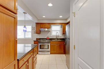 Interior of traditional kitchen blue pendant lighting on island