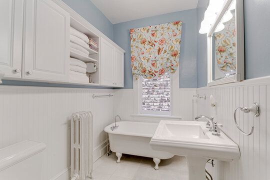 Blue And White Traditional Historic White Clawfoot Tub White Pedestal Sink Vintage Curtains And Built In Floating Shelves