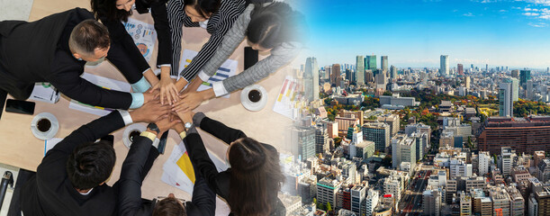 Happy business people celebrate teamwork success together with joy at office table shot from top...