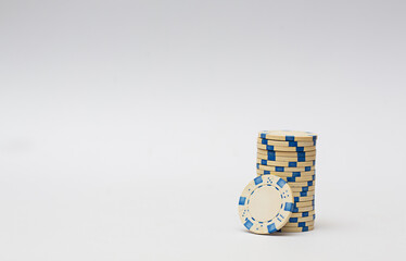 White casino chips stacked on white background. Poker game.