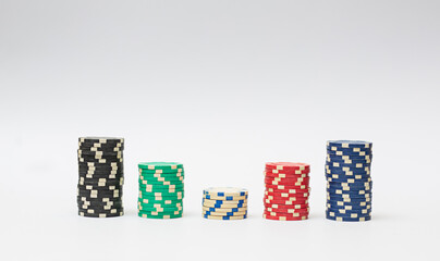 Plastic casino chips stacked on white background. Poker game.