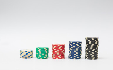 Plastic casino chips stacked on white background. Poker game.
