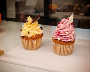 Cakes on the counter with cream and cupcake