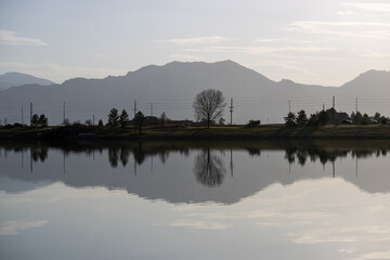 A mountain is reflected in Harper's Lake in Louisville Colorado