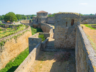 Belgorod Dniester fortress. The ruins of medieval Akkerman Fortress, Bilhorod Dnistrovskyi, Ukraine. Ruins of the citadel. Defensive moat of the stronghold on a sunny summer day.