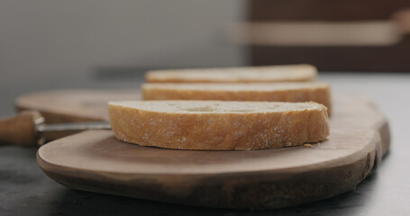 Fototapeta na wymiar ciabatta slices on olive wood board closeup