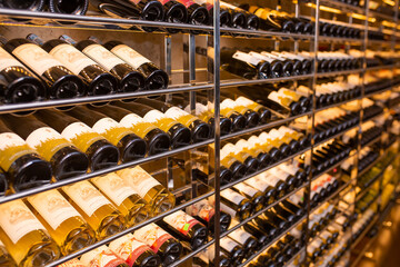 Wine cellar, storage of wine bottles. Stacks of bottles in an old dark wine cellar. Only natural...