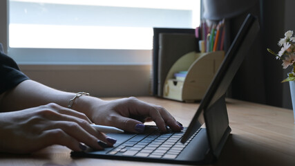 Man hands typing on wireless keyboard go digital tablet. Cropped shot.