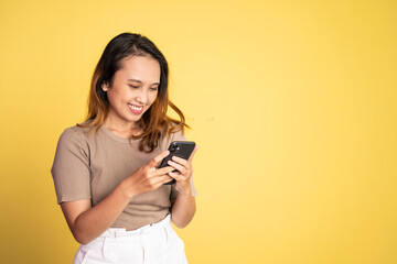 Young asian woman using smart phone typing and online browsing on social media platform